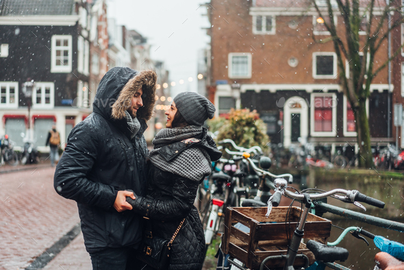 guy and girl in the street in the rain - Stock Photo - Images