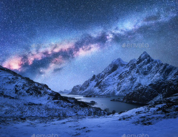 Bright Milky Way over snow covered mountains and sea bay at nigh - Stock Photo - Images