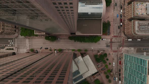 Aerial Birds Eye Overhead Top Down View of Wide Multilane Downtown Street Leading Between Tall alt