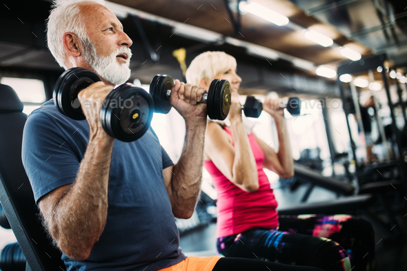 Fit senior sporty couple working out together at gym - Stock Photo - Images