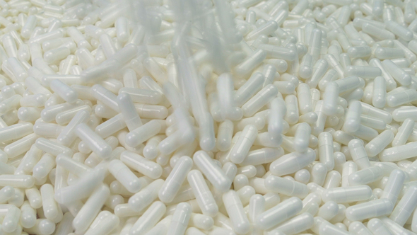 Medical Capsules Pour Into Pile alt