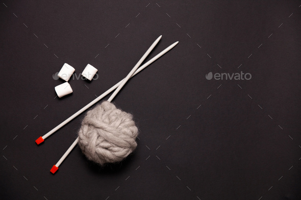 Yarn balls and sew needles on black background - Stock Photo - Images