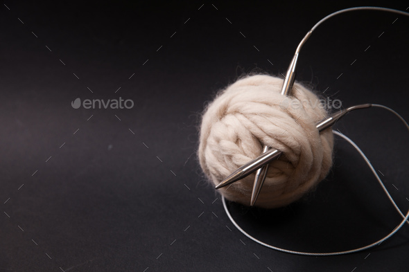 Yarn balls and sew needles on black background - Stock Photo - Images