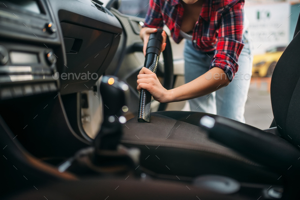 Woman cleans car interior with vacuum cleaner - Stock Photo - Images