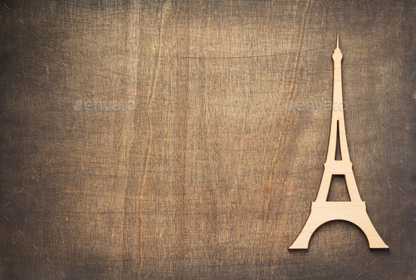 wooden eiffel tower toy at plywood background