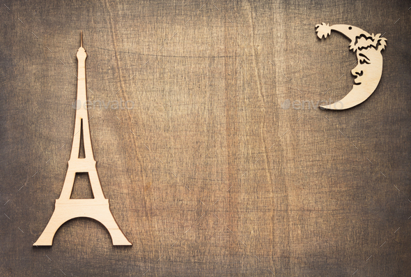 wooden eiffel tower toy at plywood background