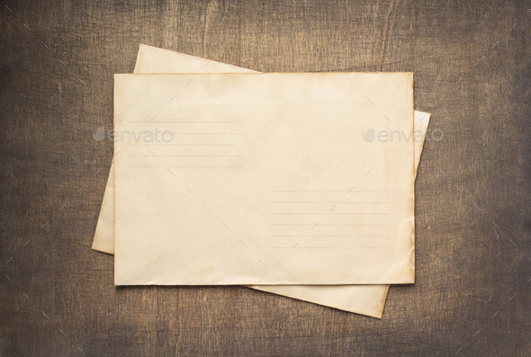 old retro aged paper parchment at wood Stock Photo by seregam