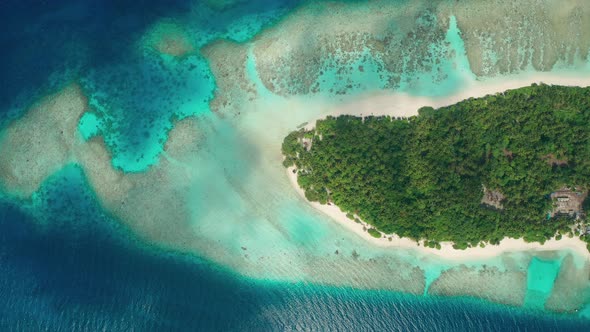 Drone flight over the ocean, coral reef, to a tropical island with a white coral beach alt