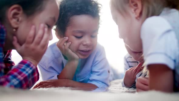 Diverse Little Kids Watching Cartoon on Tablet Together