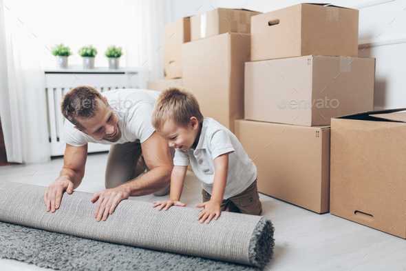 Moving concept, Father and son moving to a new home - Stock Photo - Images