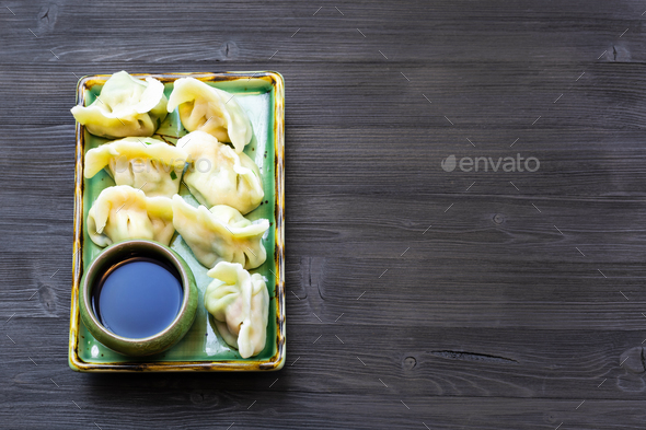 Dumplings on plate on dark table with copyspace - Stock Photo - Images