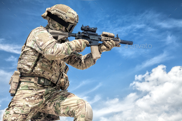 Equipped airsoft player aiming with service rifle - Stock Photo - Images