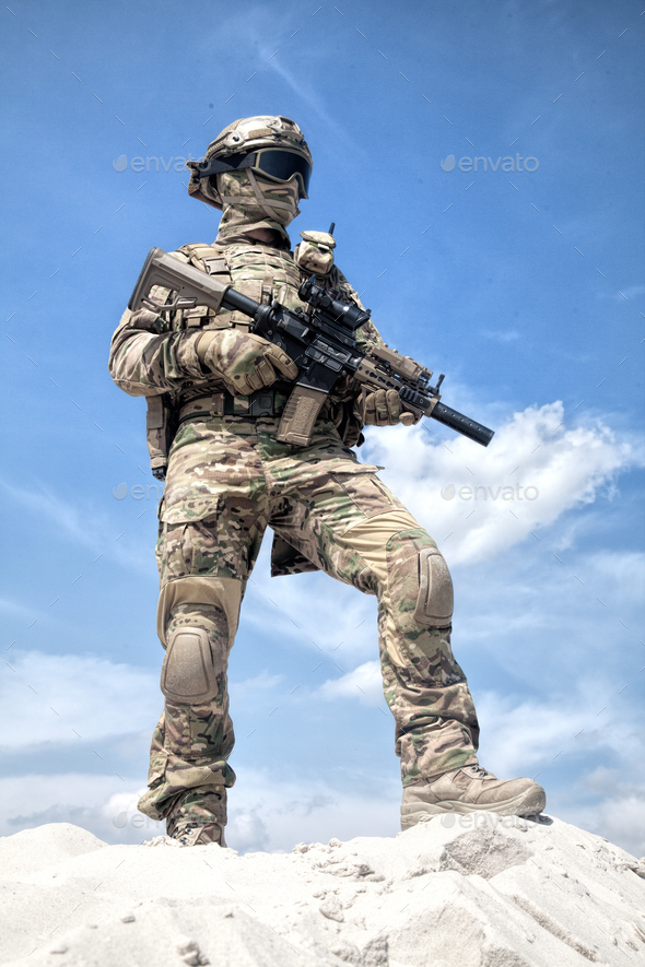 Airsoft player witt gun taking part in war games - Stock Photo - Images