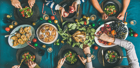 Human hands eating different meals at Christmas party dinner - Stock Photo - Images