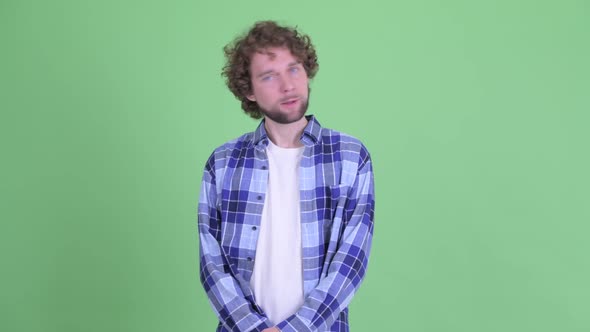 Stressed Young Bearded Hipster Man Getting Bad News alt