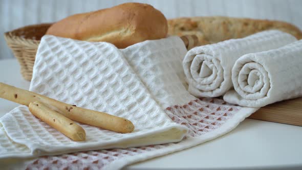 Waffle Fresh Kitchen Towels on Background of Basket with Bread and Bread Sticks