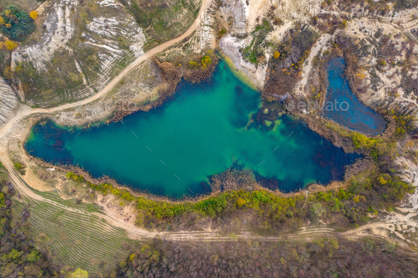 Drone view of industrial opencast mine filled with water. Aerial shot of artificial lake - Stock Photo - Images