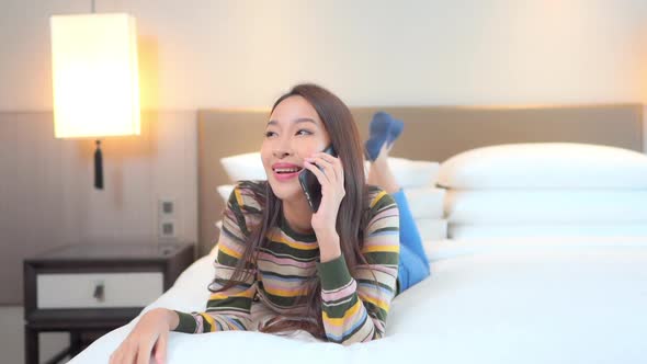 Young asian woman use smart phone alt