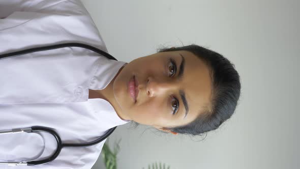 Portrait of A Young Indian Woman Doctor Looking at the Camera Dressed in a Bathrobe alt