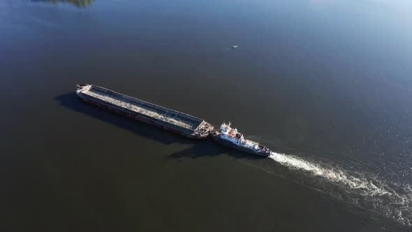 Big River Barge Floats Along the River  Drone Aerial Orbit Shot alt