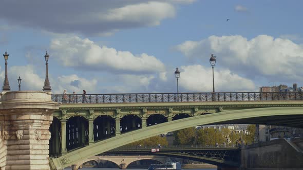 People on a bridge in Paris alt