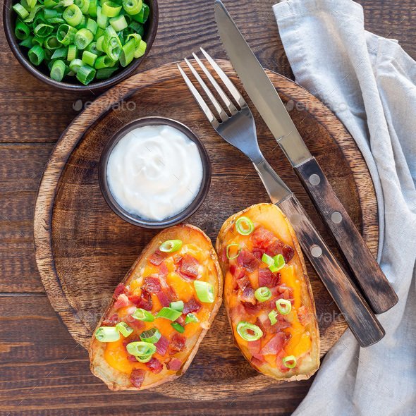 Baked loaded potato skins with cheddar cheese and bacon, garnish - Stock Photo - Images