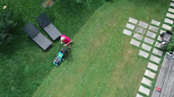 Video Footage of a Man Mowing the Lawn alt