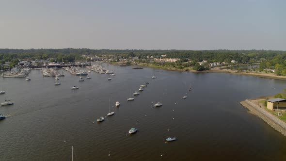 Backwards Aerial Pan of Boats Anchored at Manhasset Bay Long Island alt