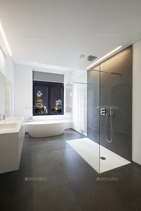 Bathtub in corian, Faucet and shower in tiled bathroom - Stock Photo - Images