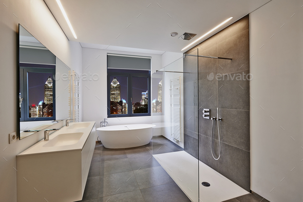 Bathtub in corian, Faucet and shower in tiled bathroom - Stock Photo - Images