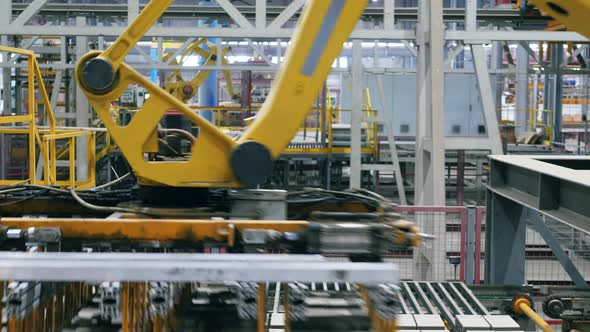 Modern Industrial Plant Machines Work with Brick Pallets in a Facility alt