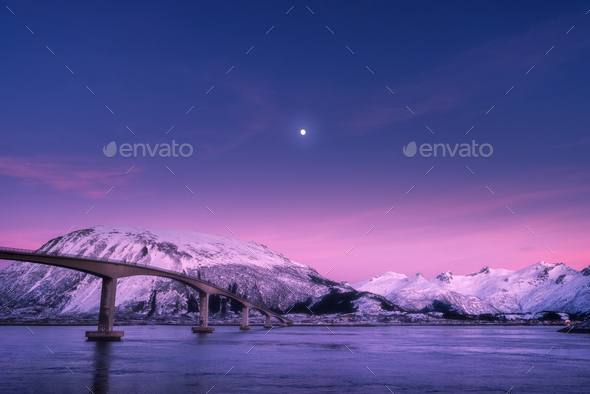 Bridge against snowy mountains, purple sky with pink clouds and moon