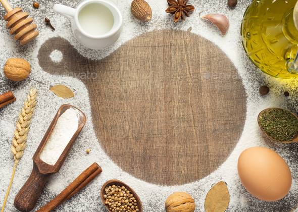 Cutting Board And Bakery Ingredients On Wooden Background Stock