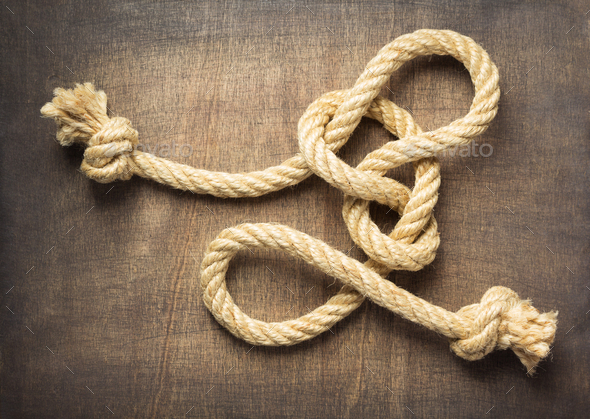 ship rope at wooden background surface Stock Photo by seregam
