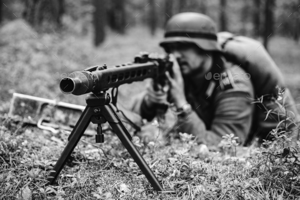 Hidden German Wehrmacht Soldier Aiming A Machine Gun At Enemy Fr