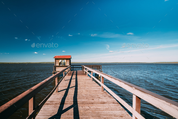 Wooden Pier For Fishing, Small House Shed And Beautiful Lake Or Stock Photo  by Great_bru