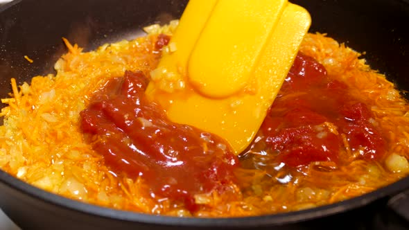 Liquid Red Dish Boils in a Pan