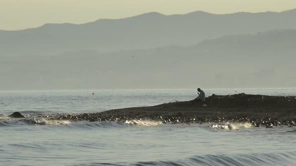 Muslim Man Praying the Koran alt