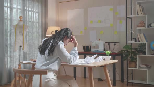 Back View Of A Asian Woman Designer Is Upset Failing Drawing On The Layout Bond And Throw It Away alt