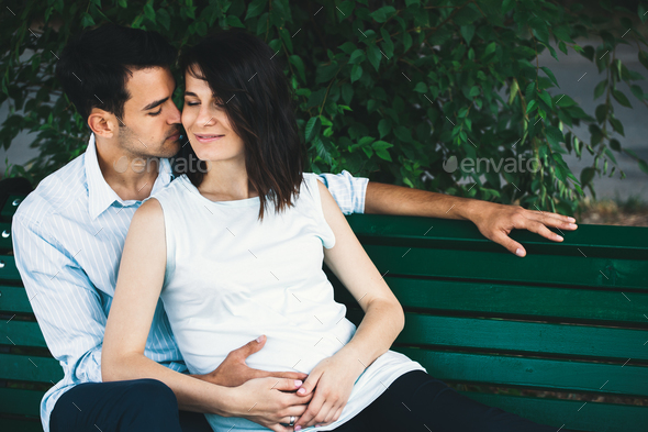 Pregnant woman touching her husband hands - Stock Photo - Images