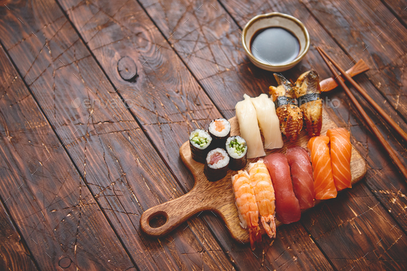 Sushi Set. Different kinds of sushi rolls on wooden serving board Stock  Photo by Daniel_Dash