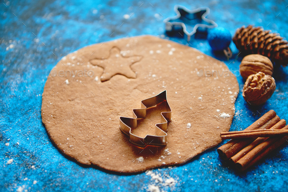 Christmas baking concept. Gingerbread dough with different cutter shapes