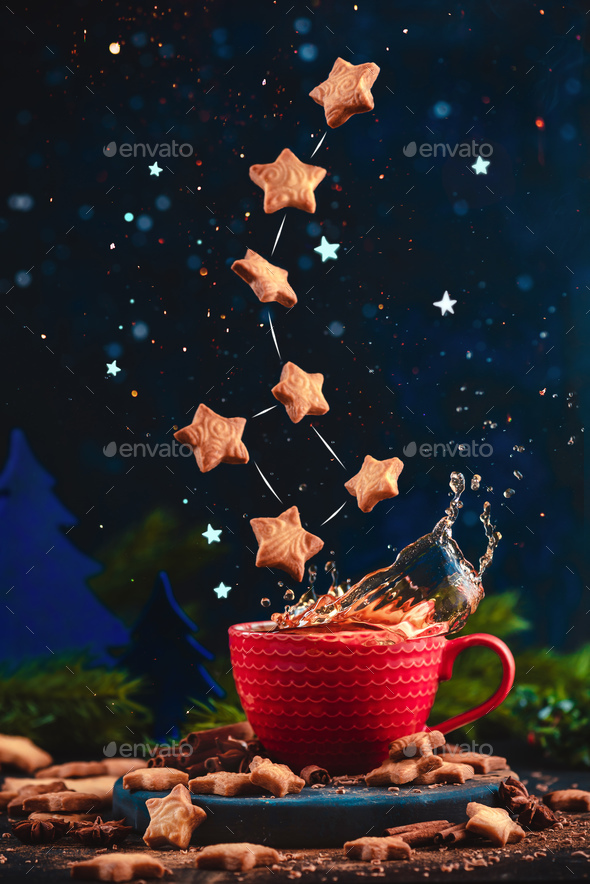 Star-shaped cookie Ursa Minor constellation with chocolate crumbs over a red cup of Christmas hot