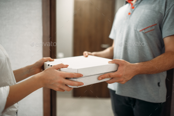 Pizza delivery man gives box to female client - Stock Photo - Images