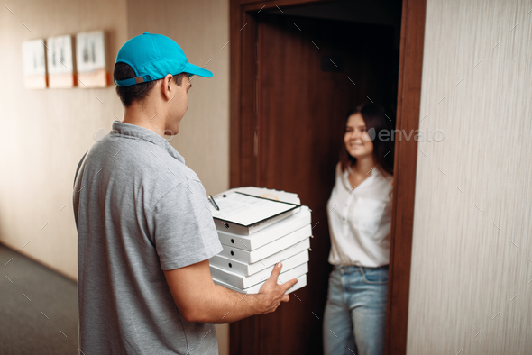 Female customer on doorstep and pizza delivery boy