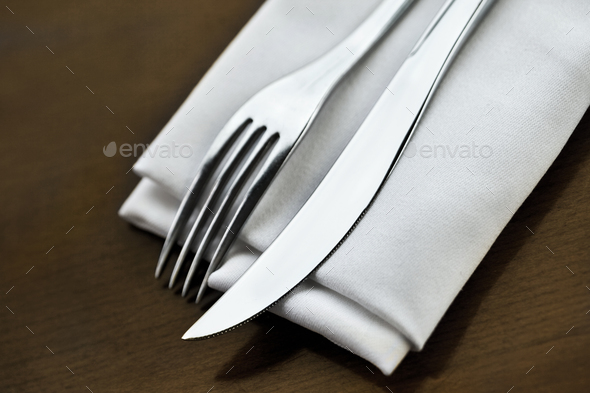 Fork and knife and napkin on a table set