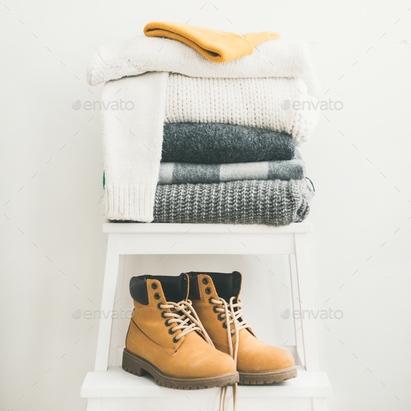 Pile of warm sweaters, blankets, cap and boots, square crop - Stock Photo - Images