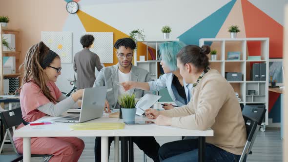 Group of Young People Designers Talking Choosing Color for Project in Office alt