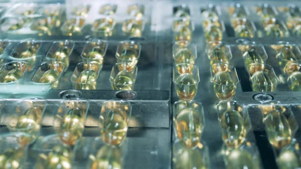 Palettes with Capsule Pills Moving Along the Transporter. Pharmaceutical Company Produces Antivirus. alt