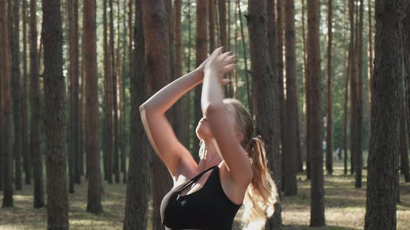 Flexible Fit Woman Practices Yoga Performs Surya Namaskar at Sunny Pine Forest